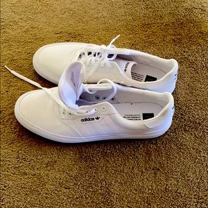 All white Adidas skate shoes